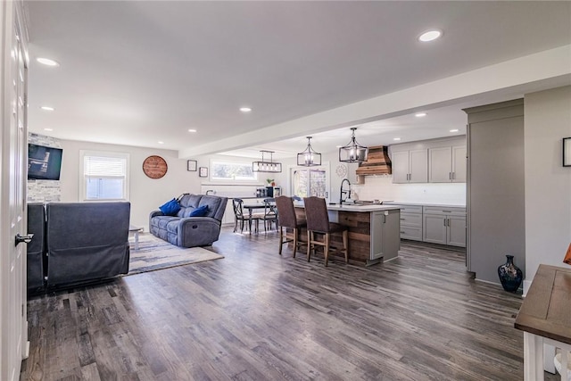 living room featuring recessed lighting and dark wood-style floors