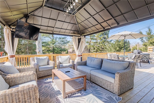 deck featuring a gazebo, outdoor dining area, and an outdoor hangout area