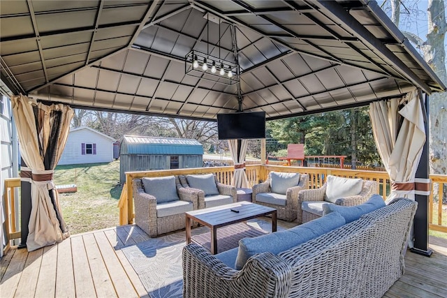 deck featuring a storage shed, an outdoor structure, a gazebo, and an outdoor hangout area