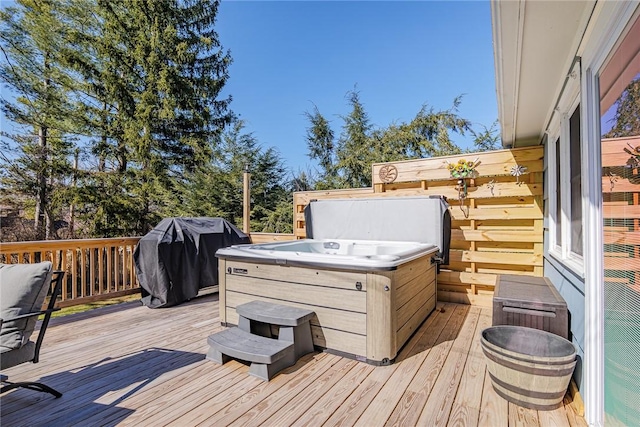 wooden terrace featuring a hot tub and a grill