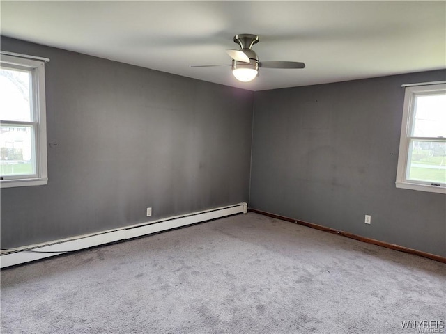 unfurnished room with a baseboard heating unit, baseboards, carpet, and a ceiling fan