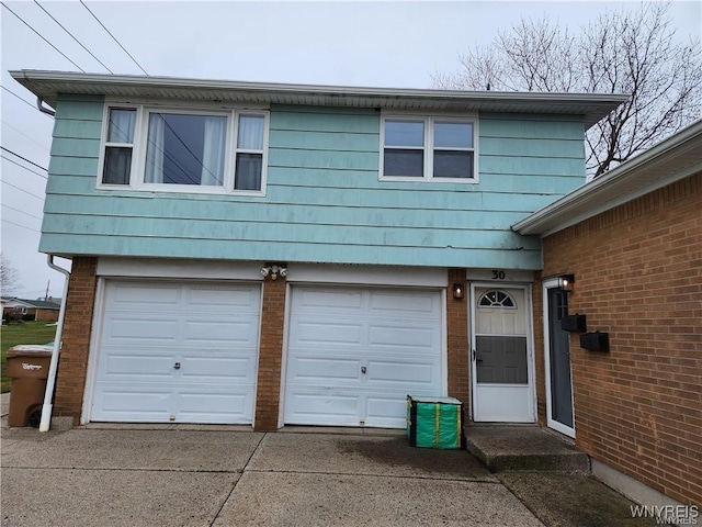 garage with concrete driveway