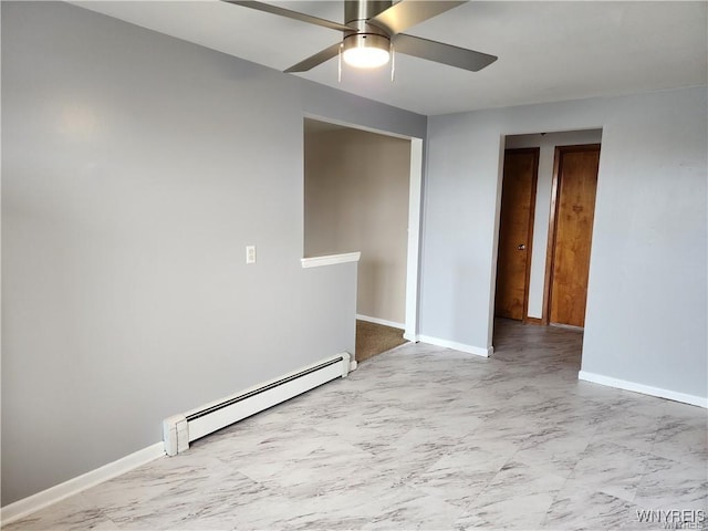 unfurnished room featuring a baseboard heating unit, baseboards, marble finish floor, and a ceiling fan