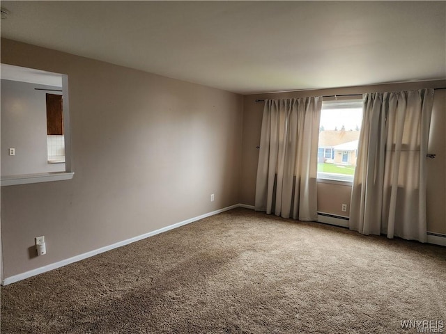 carpeted empty room with baseboards and a baseboard radiator