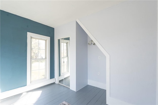 bonus room with dark wood-type flooring