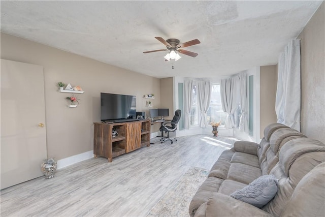 interior space with wood finished floors, baseboards, and ceiling fan