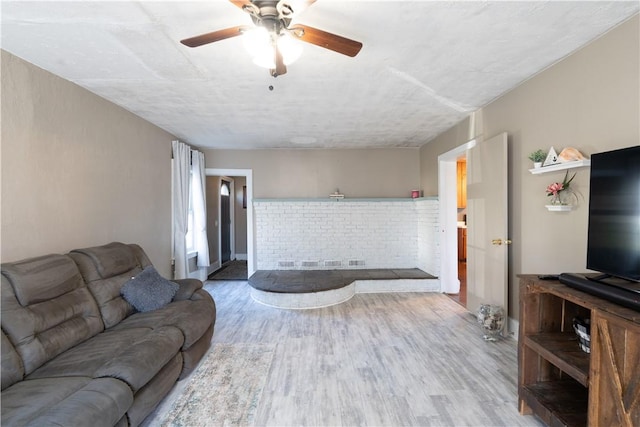 living room with ceiling fan and wood finished floors