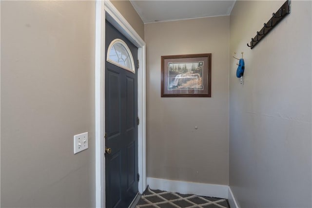 doorway to outside featuring baseboards