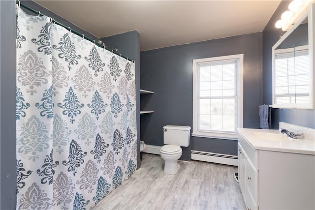 bathroom with a baseboard radiator, plenty of natural light, toilet, and wood finished floors