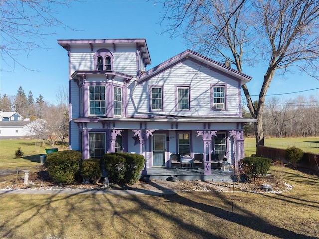 italianate house with covered porch and a front yard