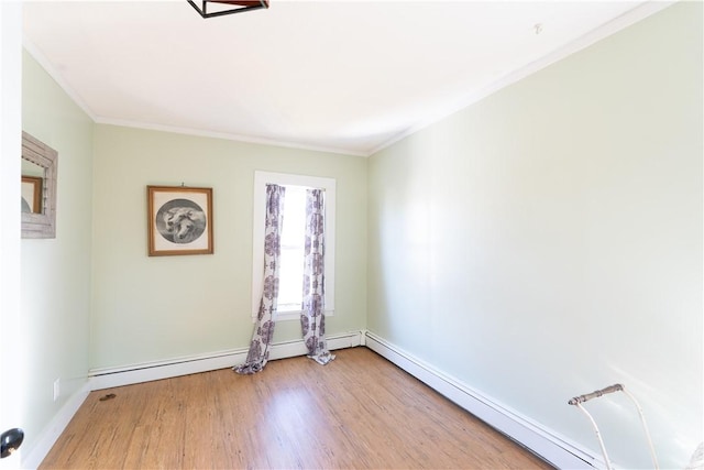 empty room with baseboards, baseboard heating, wood finished floors, and crown molding