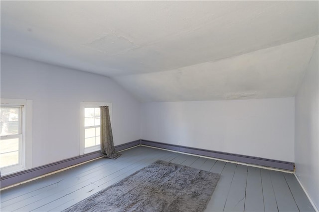 bonus room with vaulted ceiling, baseboards, and hardwood / wood-style flooring