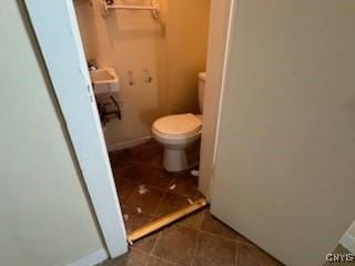 bathroom featuring tile patterned floors, toilet, and baseboards