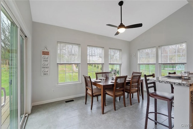 dining space with visible vents, ceiling fan, baseboards, vaulted ceiling, and light tile patterned floors