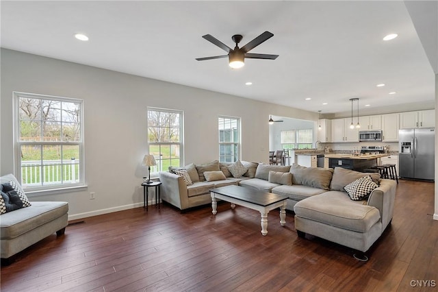 living room with recessed lighting, baseboards, ceiling fan, and dark wood-style flooring