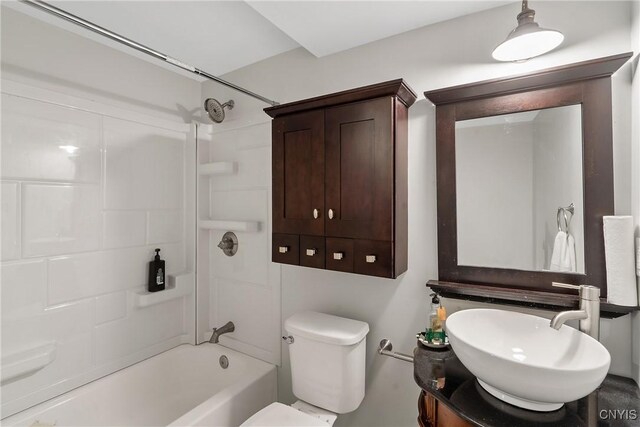 bathroom with tub / shower combination, toilet, and vanity