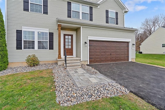 traditional home featuring a garage, a front yard, and driveway