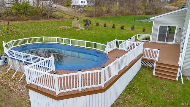 view of pool featuring a yard and a deck