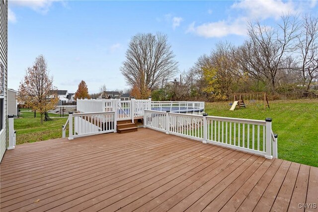 wooden deck featuring a lawn and a playground