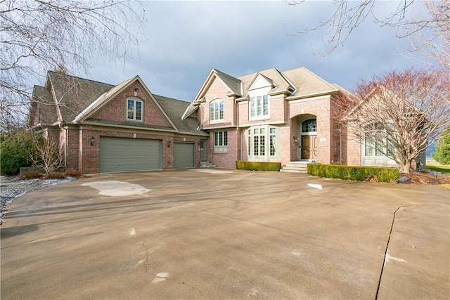 view of front of house featuring concrete driveway, a garage, and brick siding