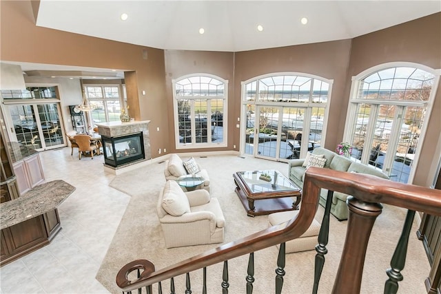 living area featuring lofted ceiling, light tile patterned floors, recessed lighting, and a multi sided fireplace