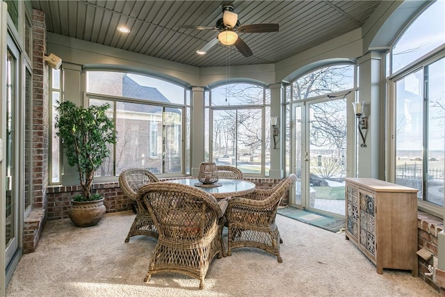 sunroom / solarium featuring plenty of natural light and ceiling fan