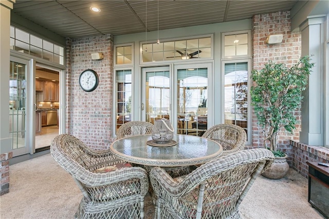 sunroom featuring a ceiling fan