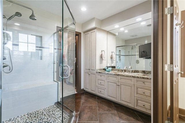 bathroom featuring tile patterned floors, recessed lighting, a stall shower, and vanity