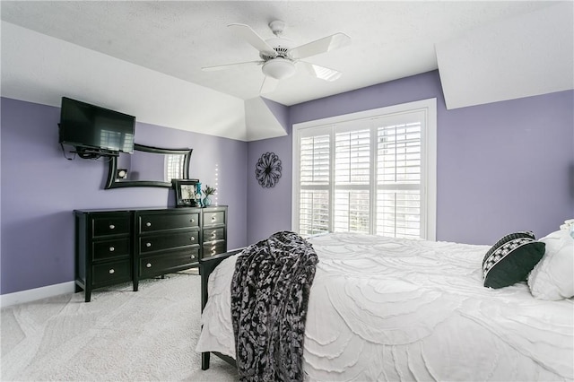 carpeted bedroom featuring baseboards and a ceiling fan