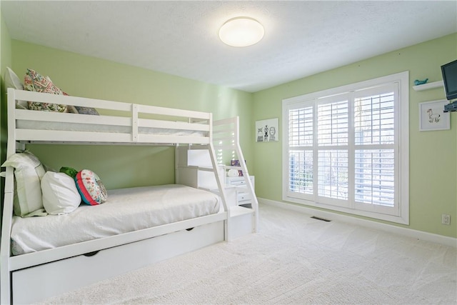 bedroom featuring baseboards, visible vents, and carpet floors