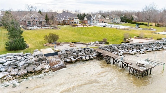 exterior space featuring a yard, a water view, and a residential view