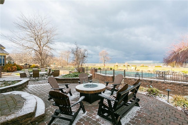 view of patio / terrace featuring a fire pit, outdoor dining area, and fence