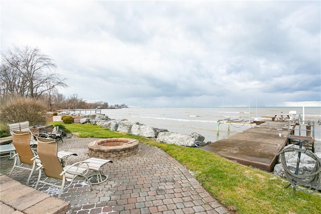 view of patio featuring a fire pit and a water view