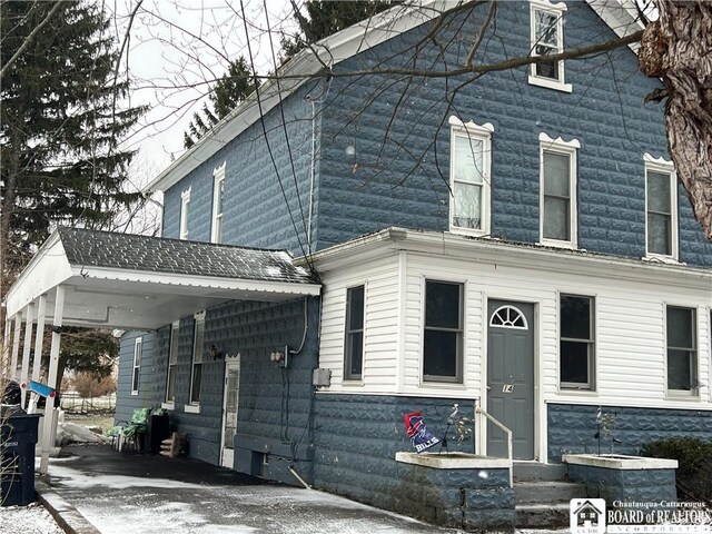 view of front of property with a carport and entry steps