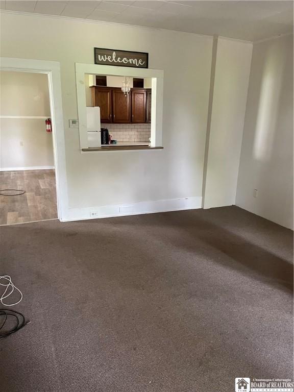 14 Moore Ave, Pomfret, NY 14063 - unfurnished living room featuring dark colored carpet
