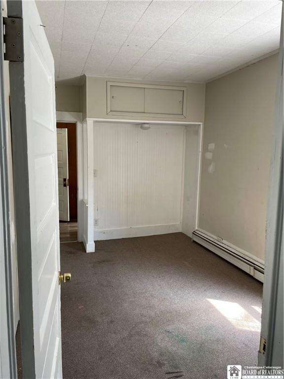 14 Moore Ave, Pomfret, NY 14063 - unfurnished bedroom with a closet, carpet, and a baseboard radiator