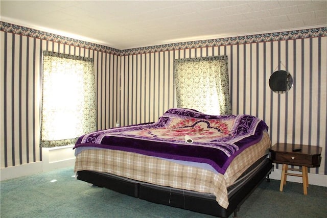 carpeted bedroom with wallpapered walls and baseboards