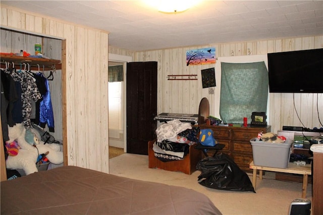 carpeted bedroom featuring wood walls