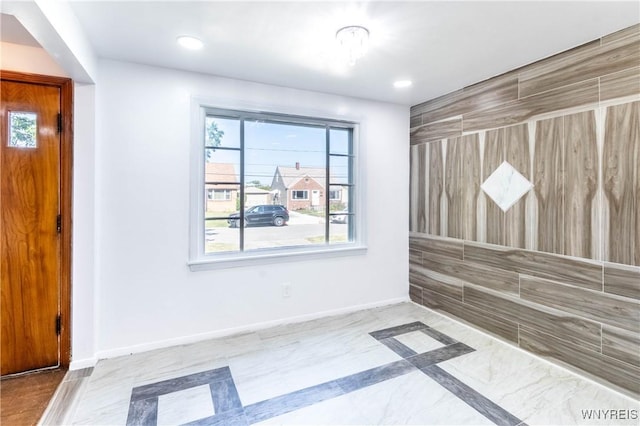 empty room featuring recessed lighting and baseboards