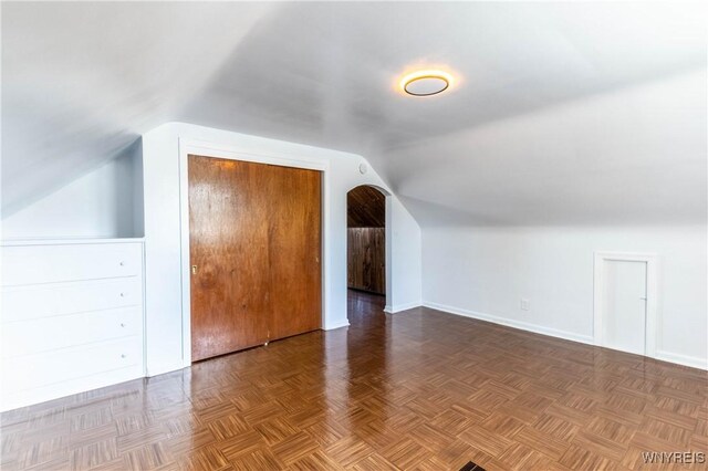 additional living space featuring lofted ceiling and baseboards