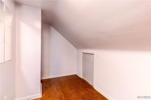 bonus room featuring vaulted ceiling and baseboards