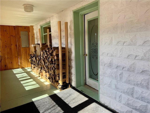 interior space featuring electric panel and wooden walls