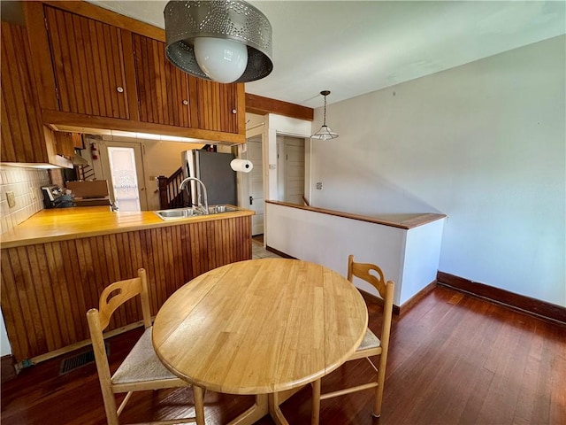 dining space with hardwood / wood-style floors and baseboards