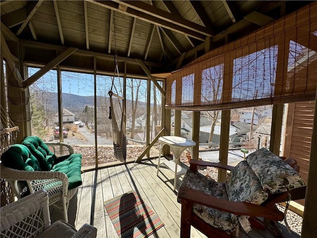 sunroom / solarium featuring wooden ceiling, vaulted ceiling with beams, and a mountain view