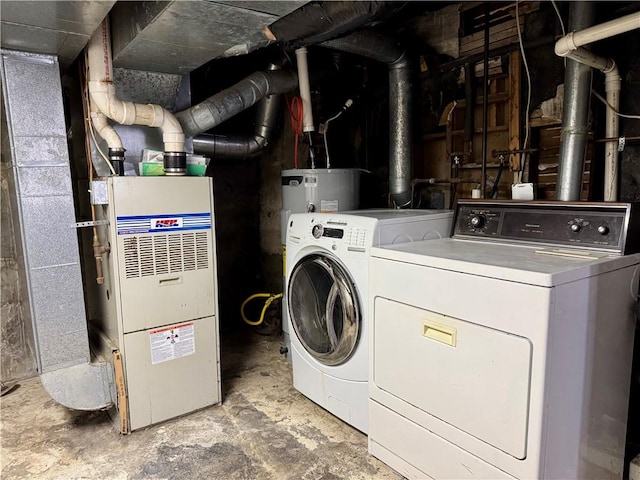 clothes washing area with laundry area, separate washer and dryer, and electric water heater