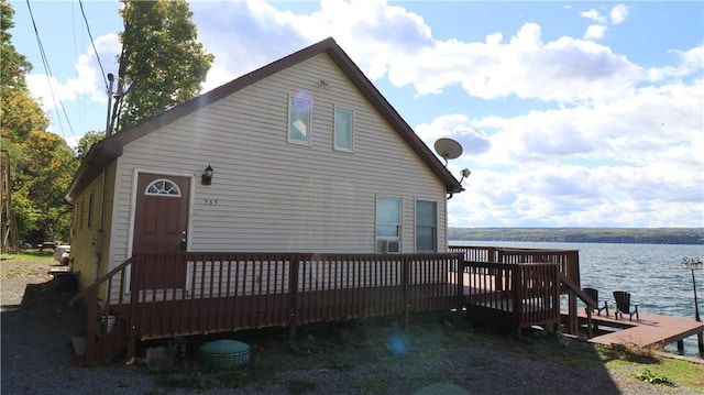 exterior space featuring a deck with water view