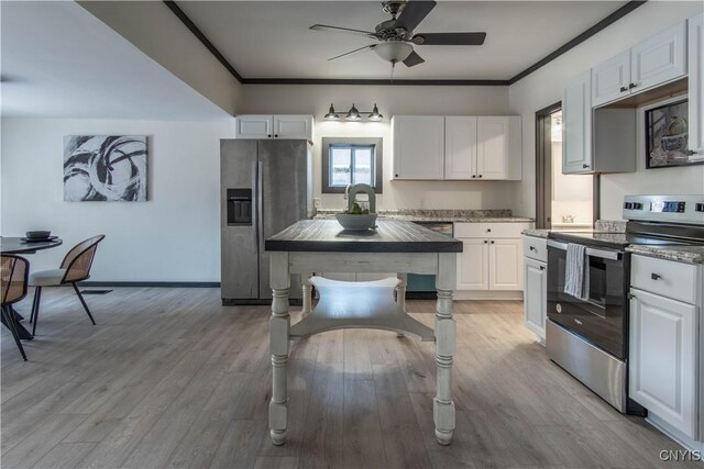 kitchen with stainless steel appliances, ornamental molding, and white cabinets