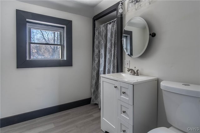 21 Avery Ave, Alexandria, NY 13607 - bathroom with vanity, toilet, wood finished floors, and baseboards