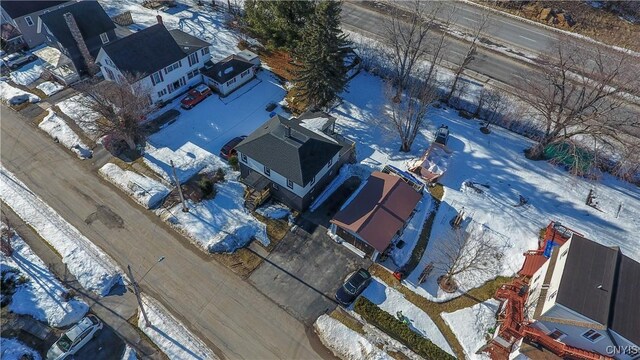 snowy aerial view featuring a residential view