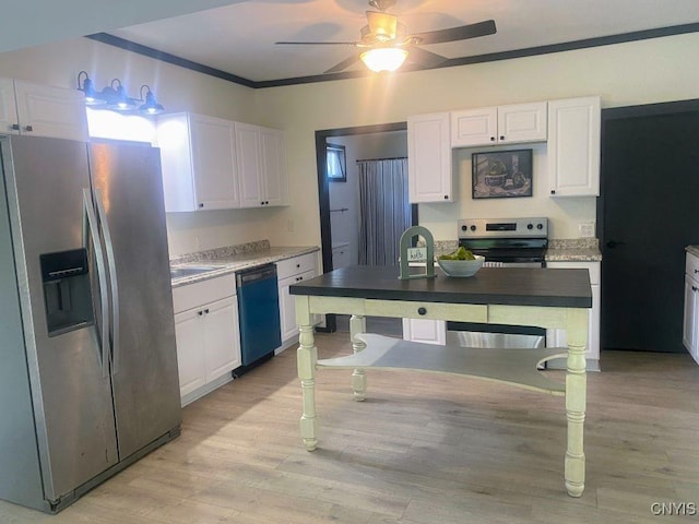 21 Avery Ave, Alexandria, NY 13607 - kitchen featuring stainless steel appliances, white cabinets, a ceiling fan, crown molding, and light wood-type flooring